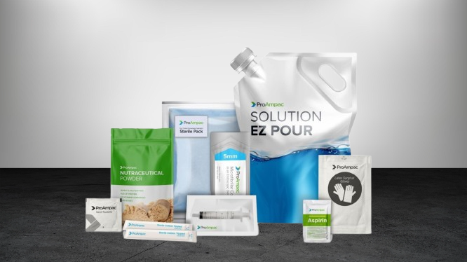 Pharmaceutical packaging products like pouches and blister packs placed on pink fabric background for display
